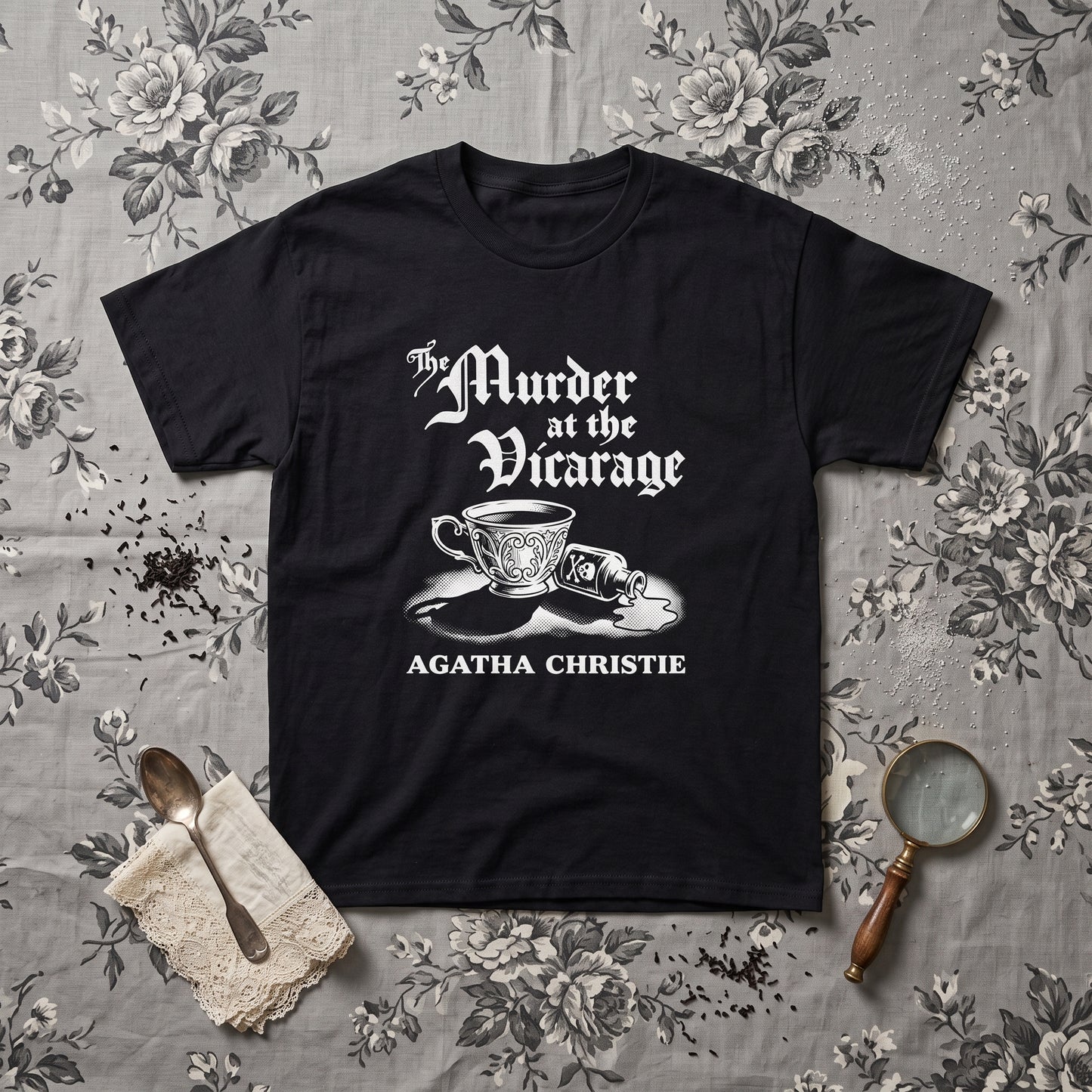 Murder at the Vicarage Agatha Christie black graphic tee, styled flat lay