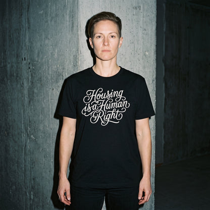 Woman wearing the Housing is a Human Right black graphic tee