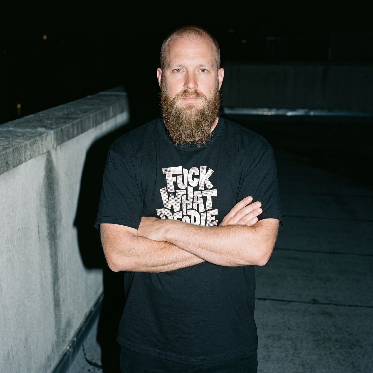 Man wearing the Fuck What People Think black graphic tee