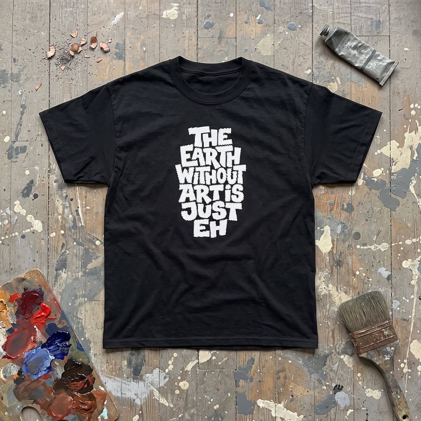 The Earth Without Art is Just Eh black graphic tee, styled flat lay