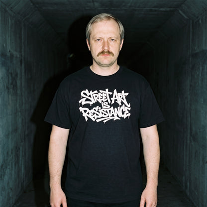 Man wearing the Street Art is Resistance black graphic tee