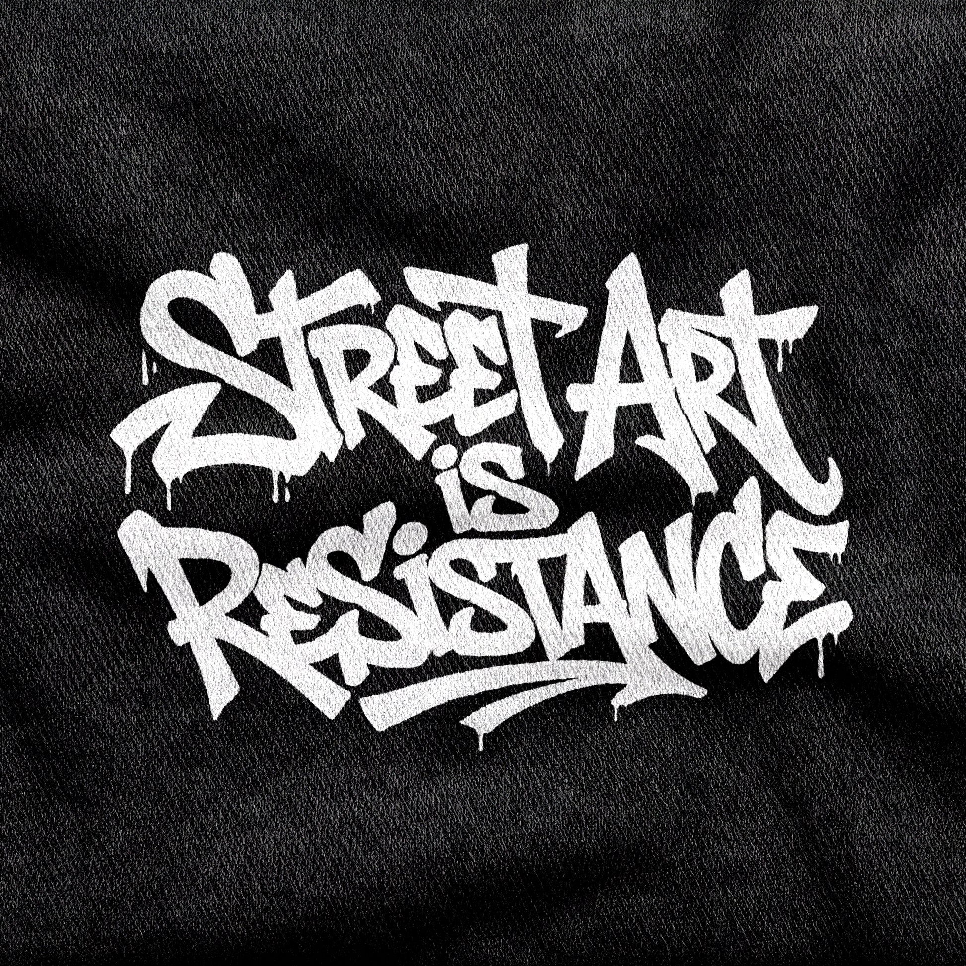 Street Art is Resistance design printed on a black cotton tee, close-up