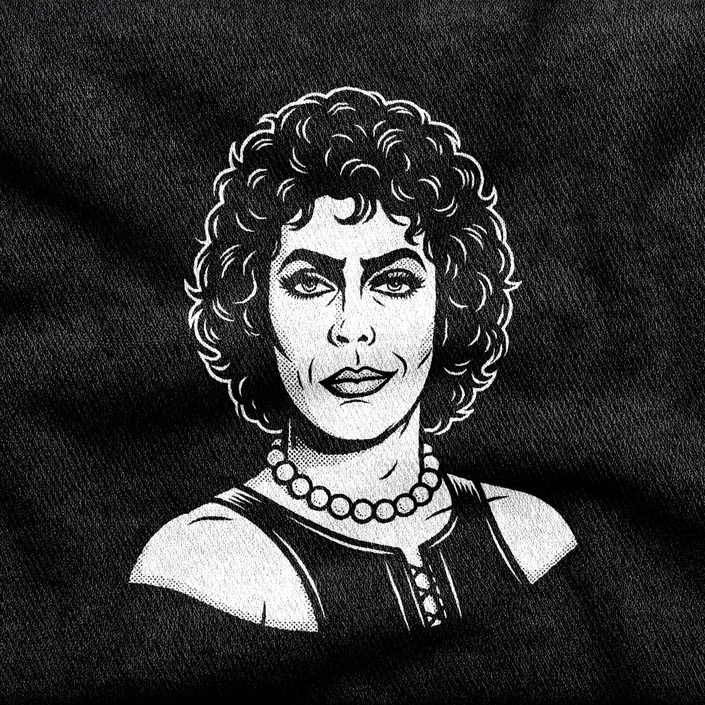 Frank-N-Furter design printed on a black cotton tee, close-up
