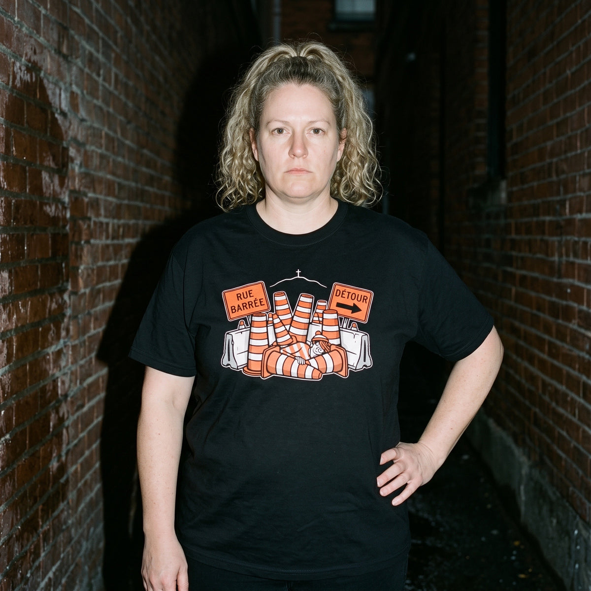 Woman wearing the Waldo in Montreal black graphic tee