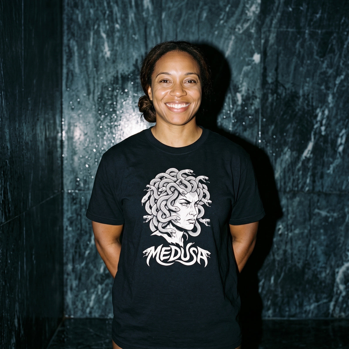 Woman wearing the Medusa black graphic tee