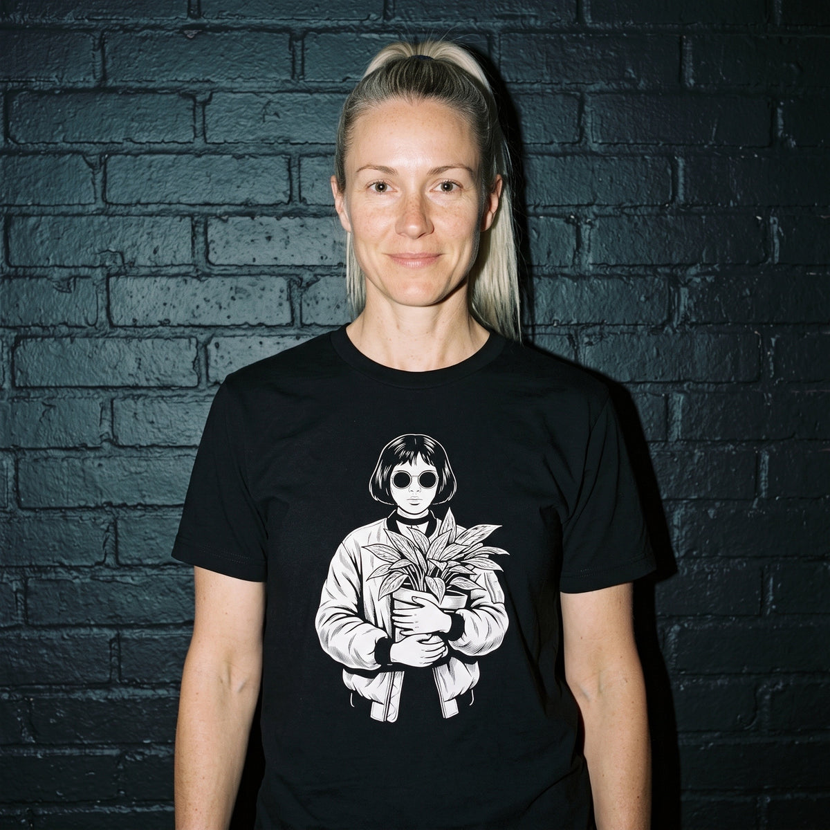 Woman wearing the Mathilda black graphic tee