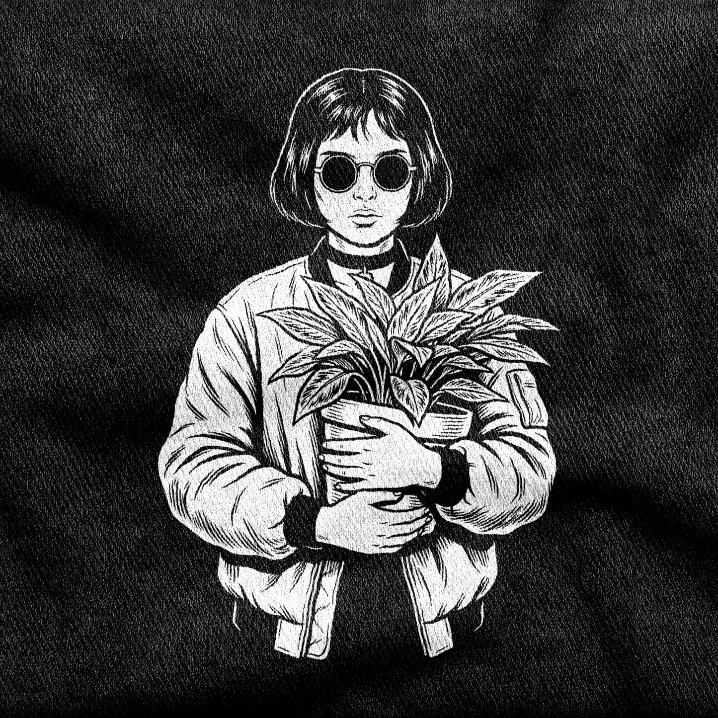 Mathilda design printed on a black cotton tee, close-up