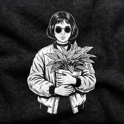 Mathilda design printed on a black cotton tee, close-up
