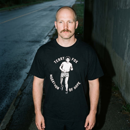 Man wearing the Terry Fox Marathon of Hope black graphic tee