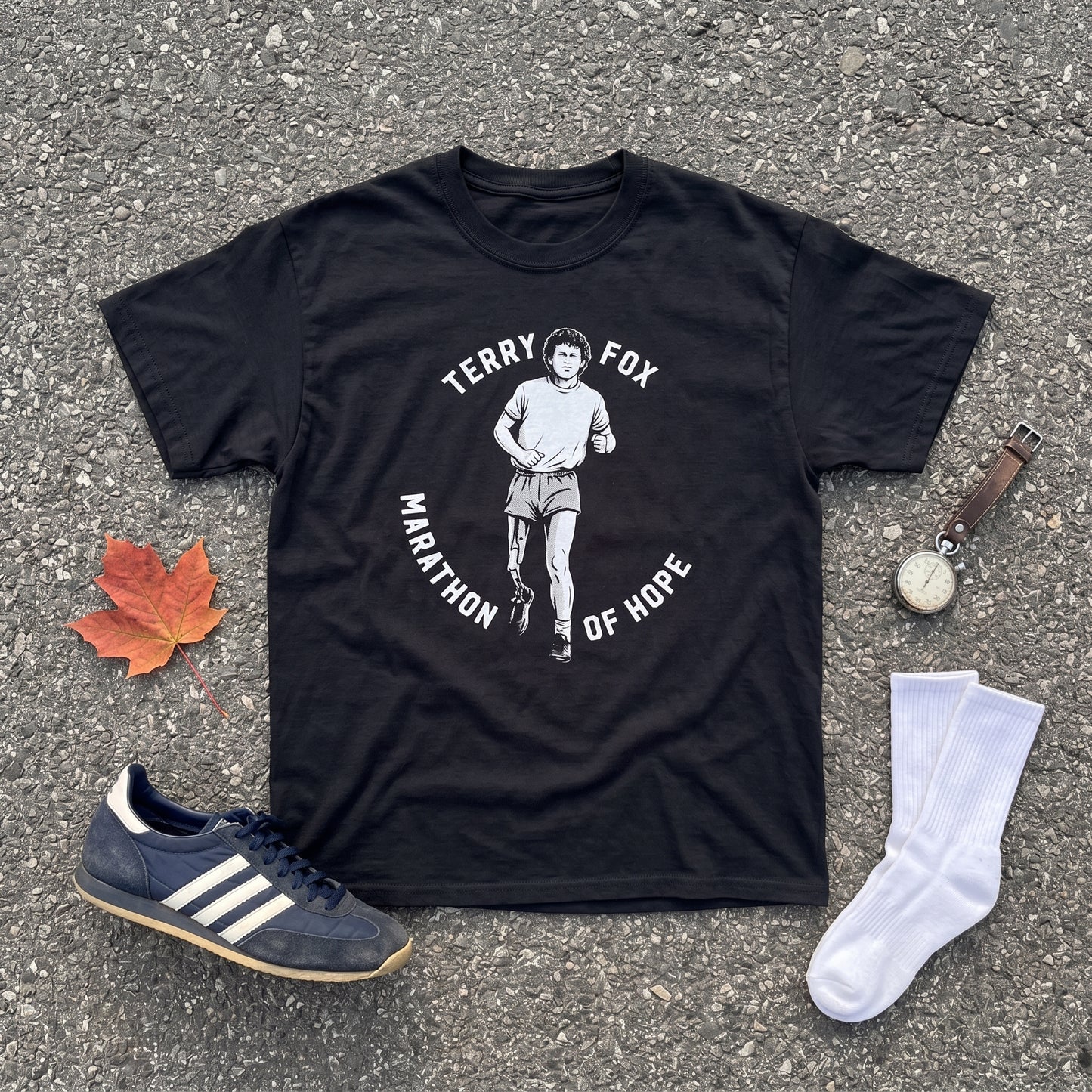 Terry Fox Marathon of Hope black graphic tee, styled flat lay
