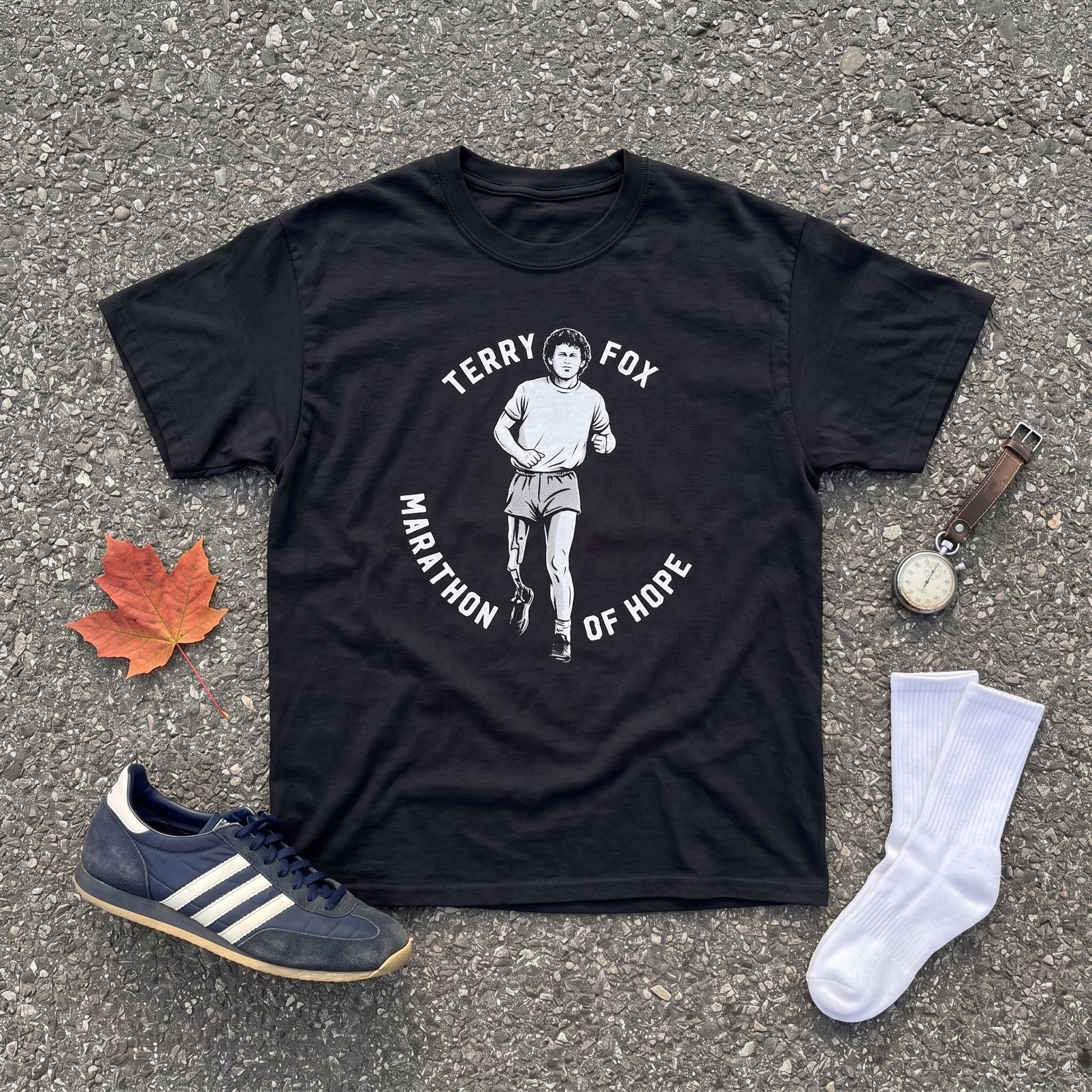 Terry Fox Marathon of Hope black graphic tee, styled flat lay