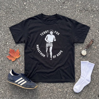 Terry Fox Marathon of Hope black graphic tee, styled flat lay