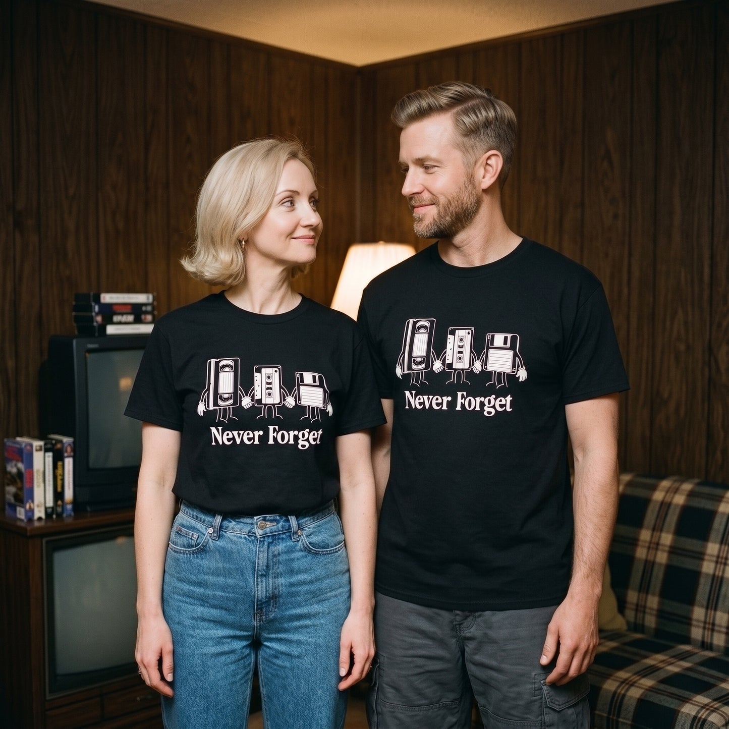 Two models wearing the Never Forget black graphic tee