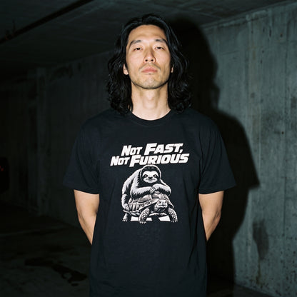 Man wearing the Not Fast, Not Furious black graphic tee
