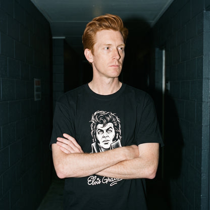 Man wearing the Elvis Gratton black graphic tee