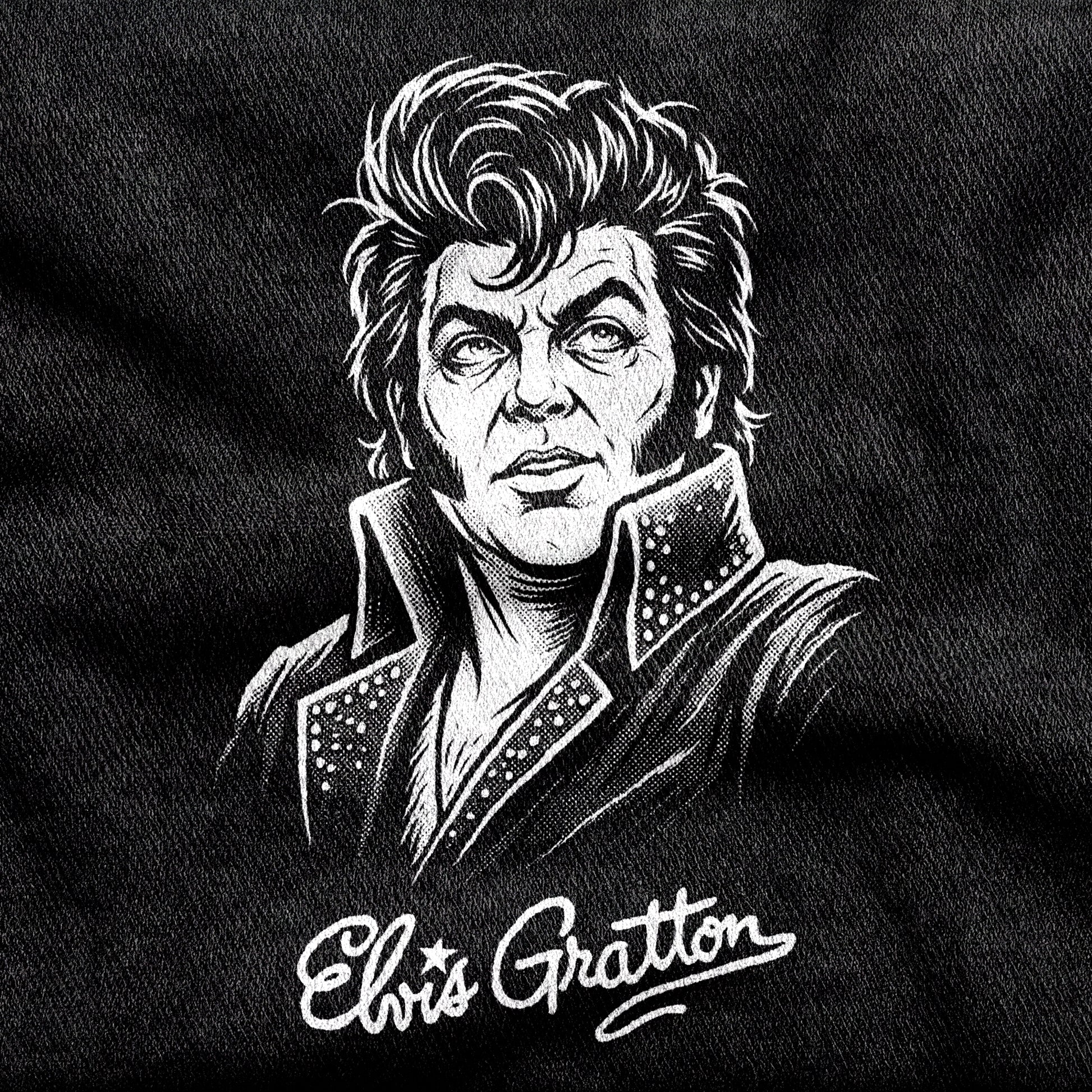Elvis Gratton design printed on a black cotton tee, close-up