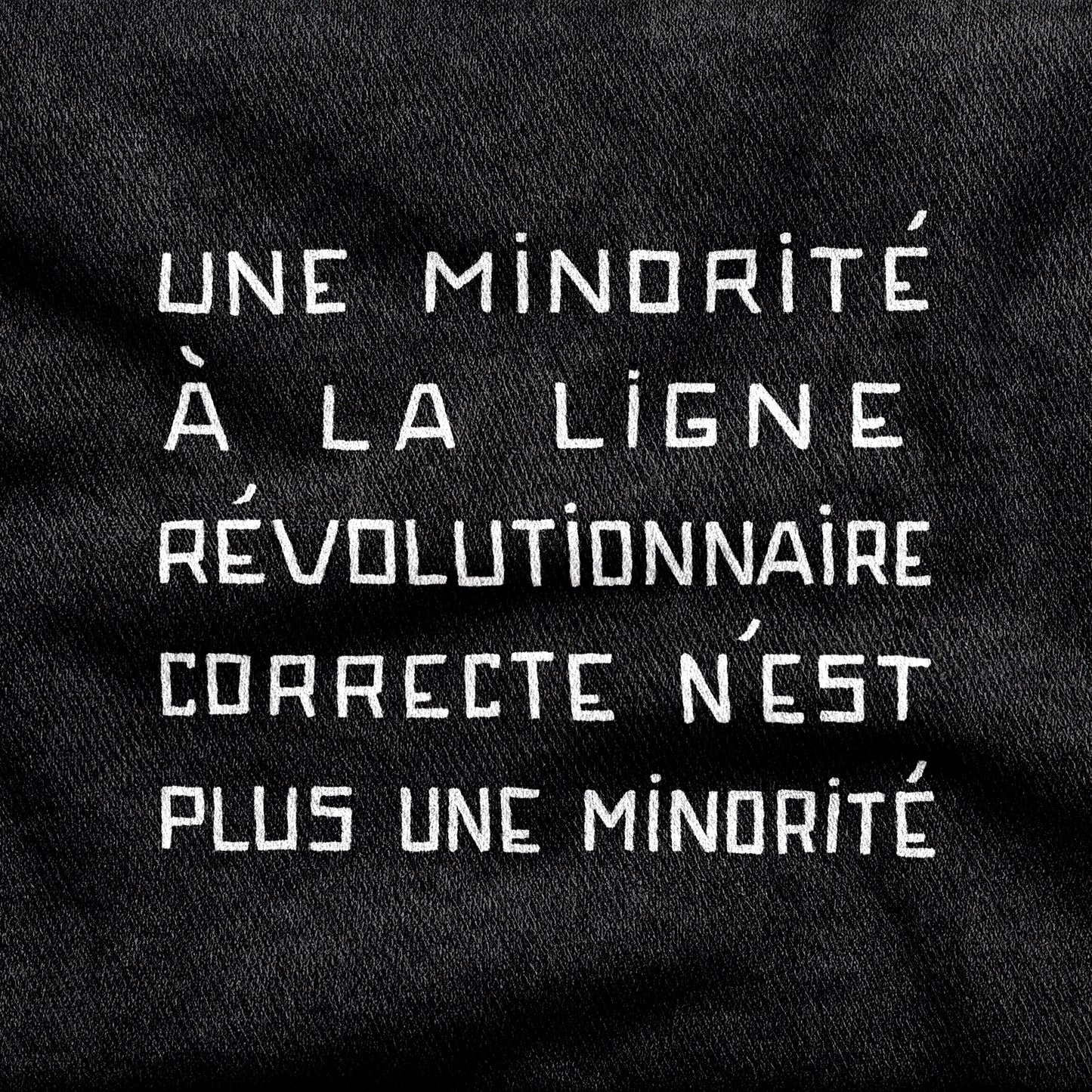 Une Minorité à la Ligne Révolutionnaire Correcte n'est plus une Minorité design printed on a black cotton tee, close-up