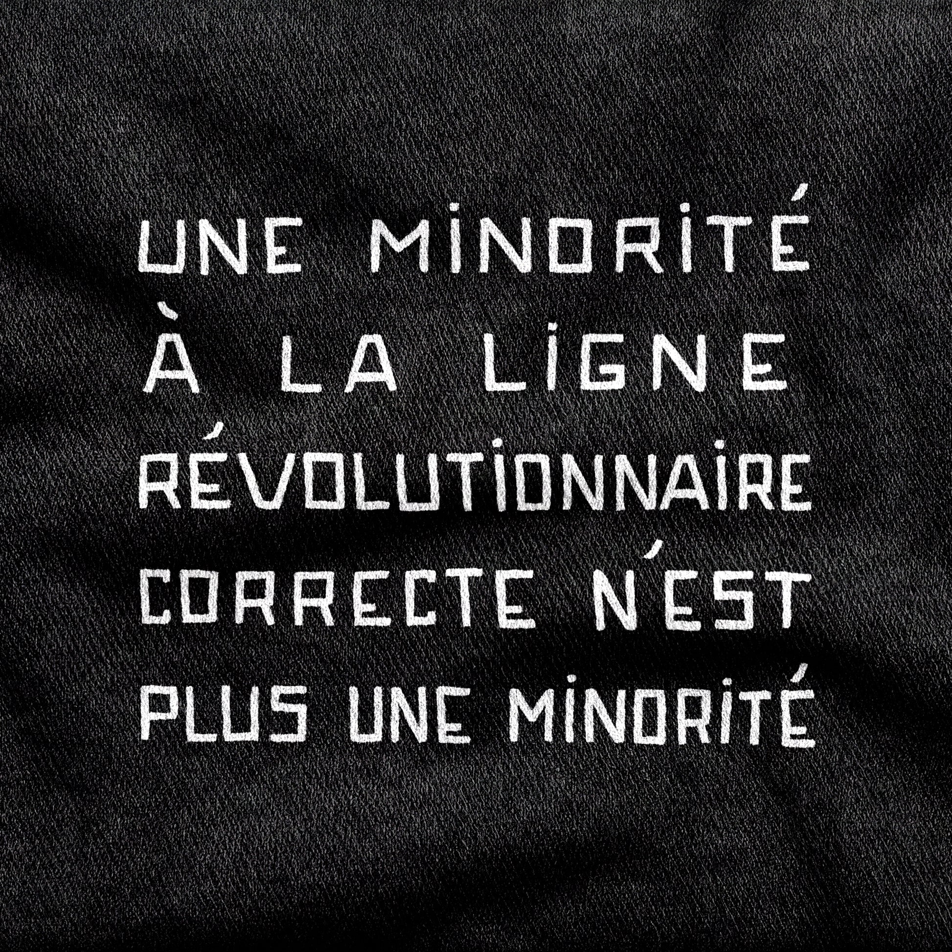 Une Minorité à la Ligne Révolutionnaire Correcte n'est plus une Minorité design printed on a black cotton tee, close-up