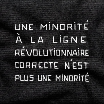 Une Minorité à la Ligne Révolutionnaire Correcte n'est plus une Minorité design printed on a black cotton tee, close-up