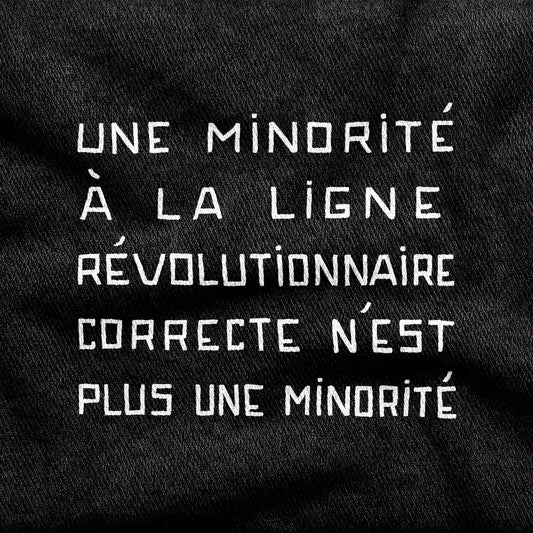 Une Minorité à la Ligne Révolutionnaire Correcte n'est plus une Minorité design printed on a black cotton tee, close-up