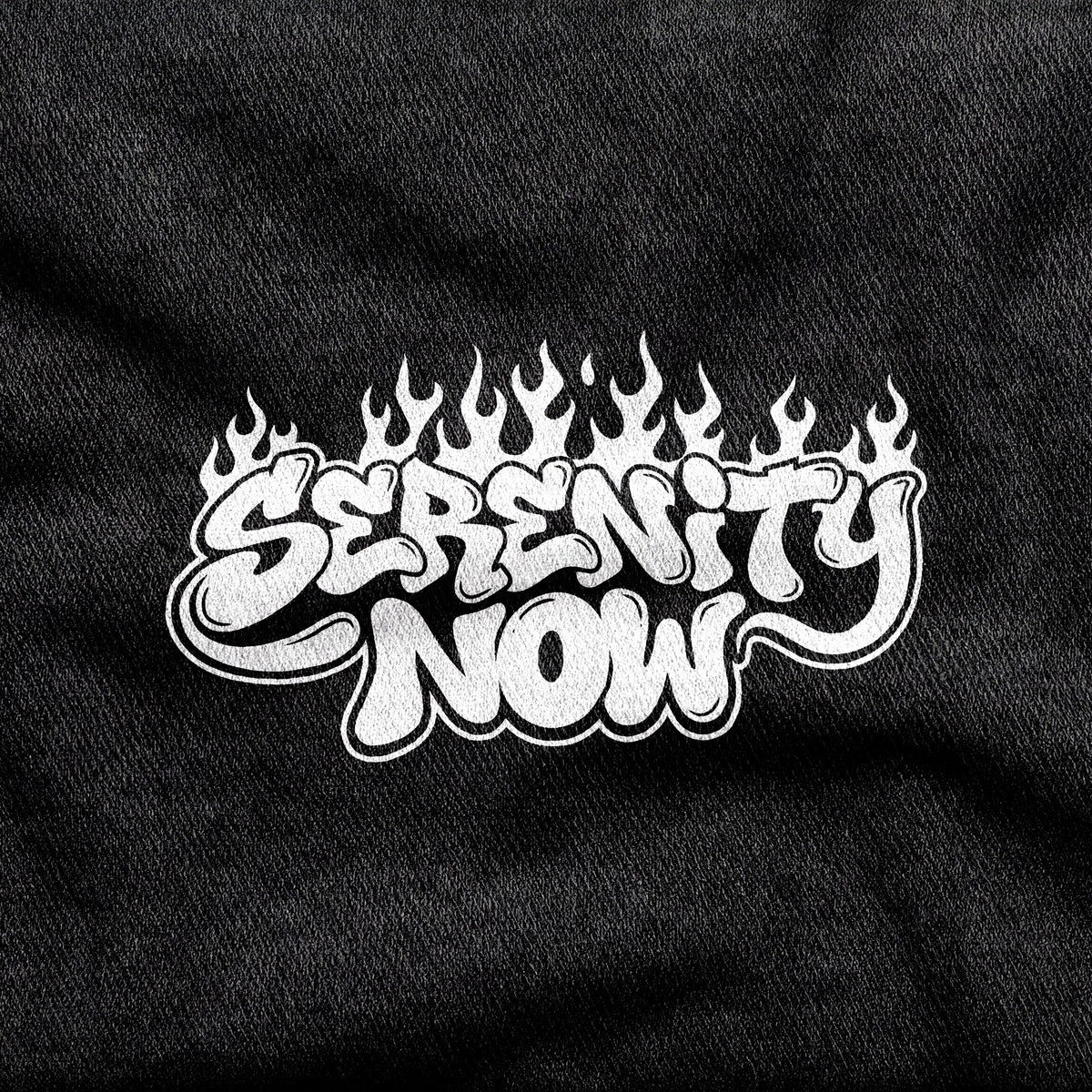 Serenity Now design printed on a black cotton tee, close-up