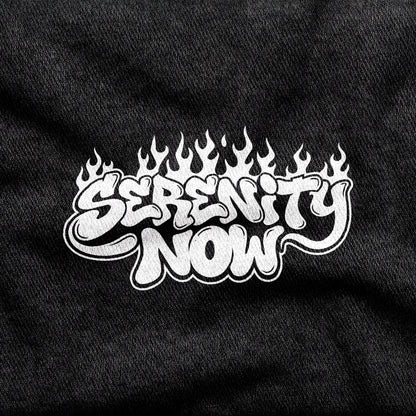 Serenity Now design printed on a black cotton tee, close-up