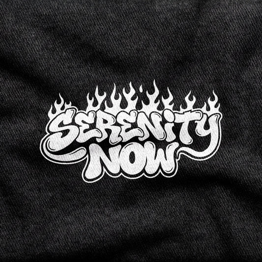 Serenity Now design printed on a black cotton tee, close-up