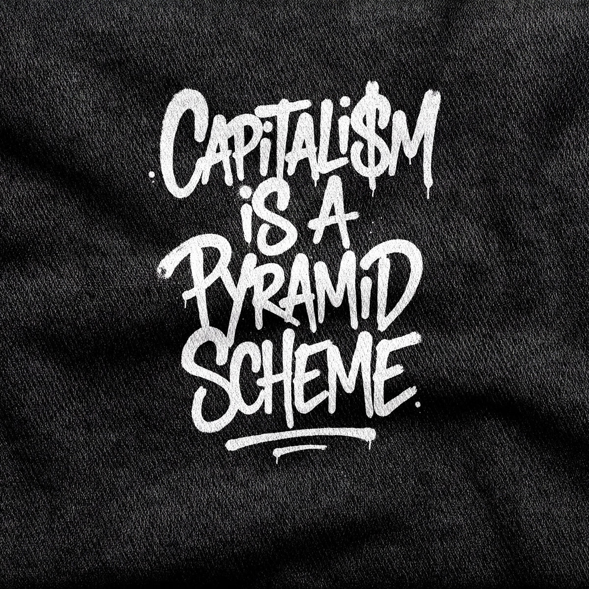 Capitalism is a Pyramid Scheme design printed on a black cotton tee, close-up