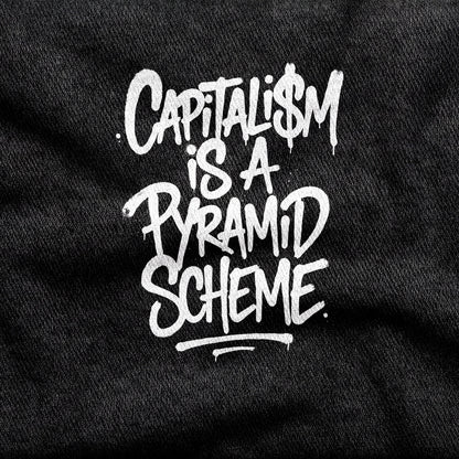 Capitalism is a Pyramid Scheme design printed on a black cotton tee, close-up