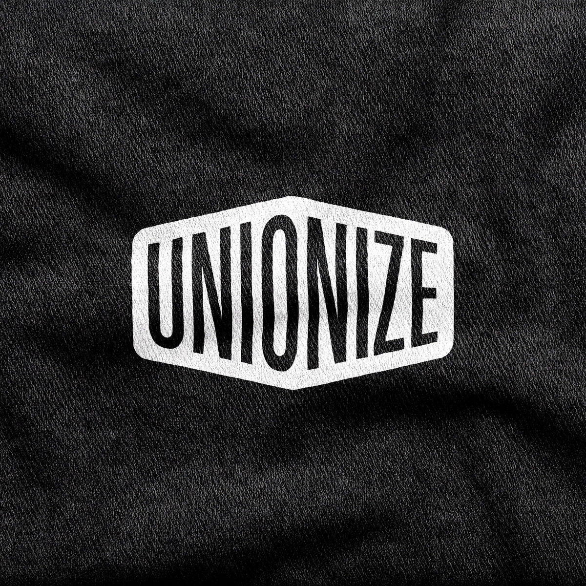 Unionize design printed on a black cotton tee, close-up
