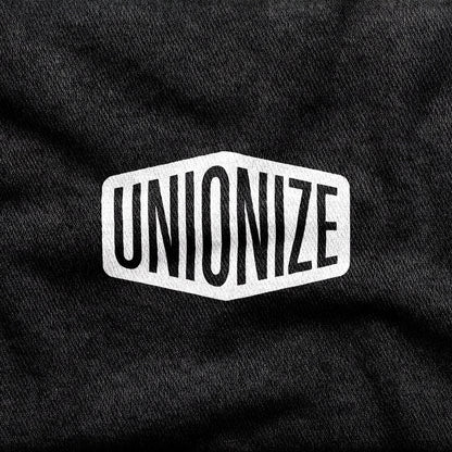 Unionize design printed on a black cotton tee, close-up