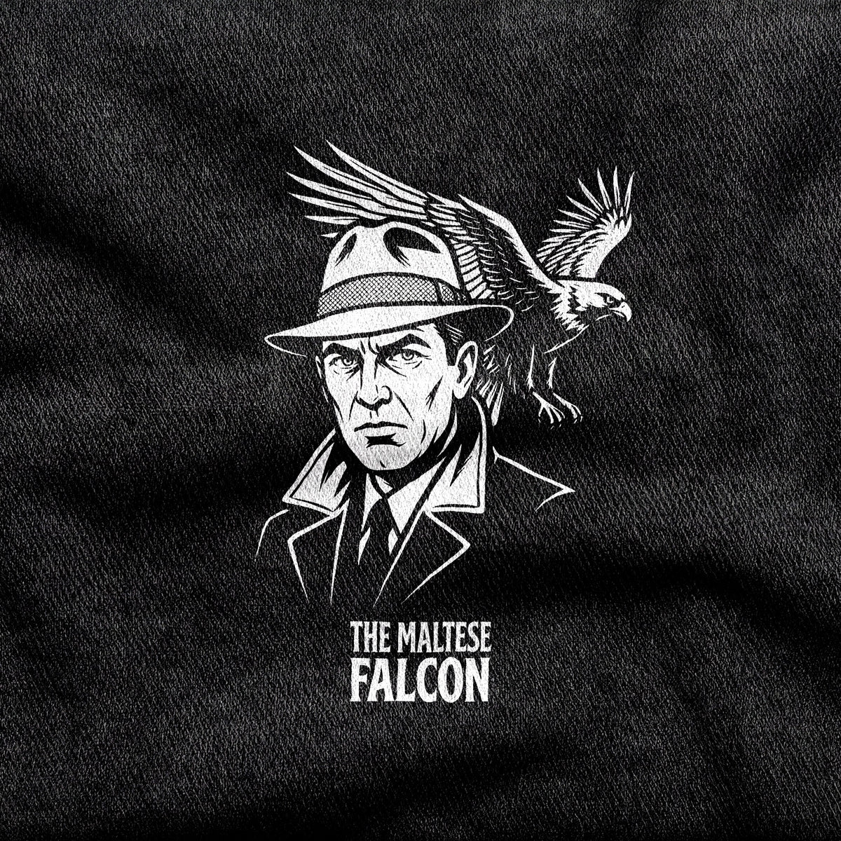 The Maltese Falcon design printed on a black cotton tee, close-up
