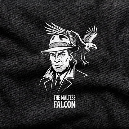 The Maltese Falcon design printed on a black cotton tee, close-up