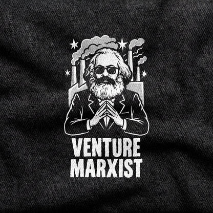 Venture Marxist design printed on a black cotton tee, close-up