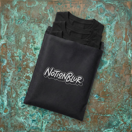 Three folded Notionblur tees in a black mailer on aged copper