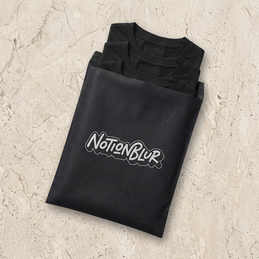 Three folded Notionblur tees in a black mailer on pale limestone